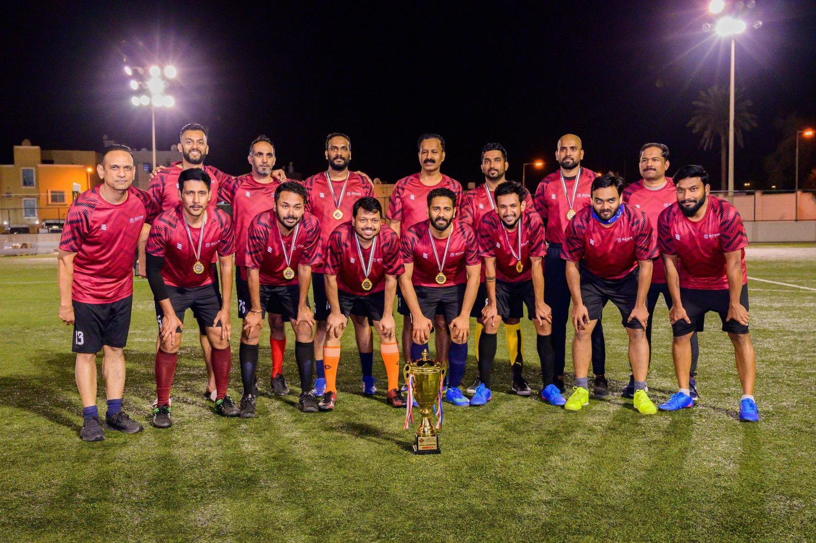 ACME football team celebrating with the Intercompany Football Championship trophy 2024